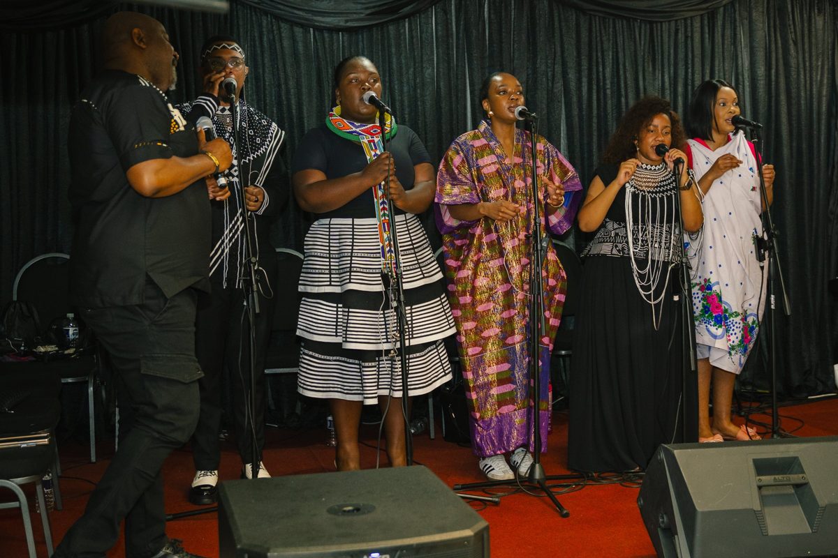The worship team singing on stage in traditional and contemporary African attire